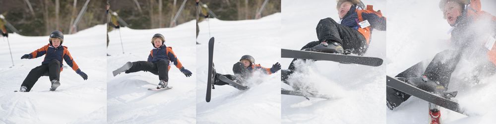 Bride and groom laughing at a wedding reception while a man gives a speech.
