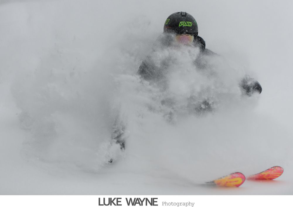 Wedding couple, in formal attire, playfully kicks up dress. Outdoor setting, at night.