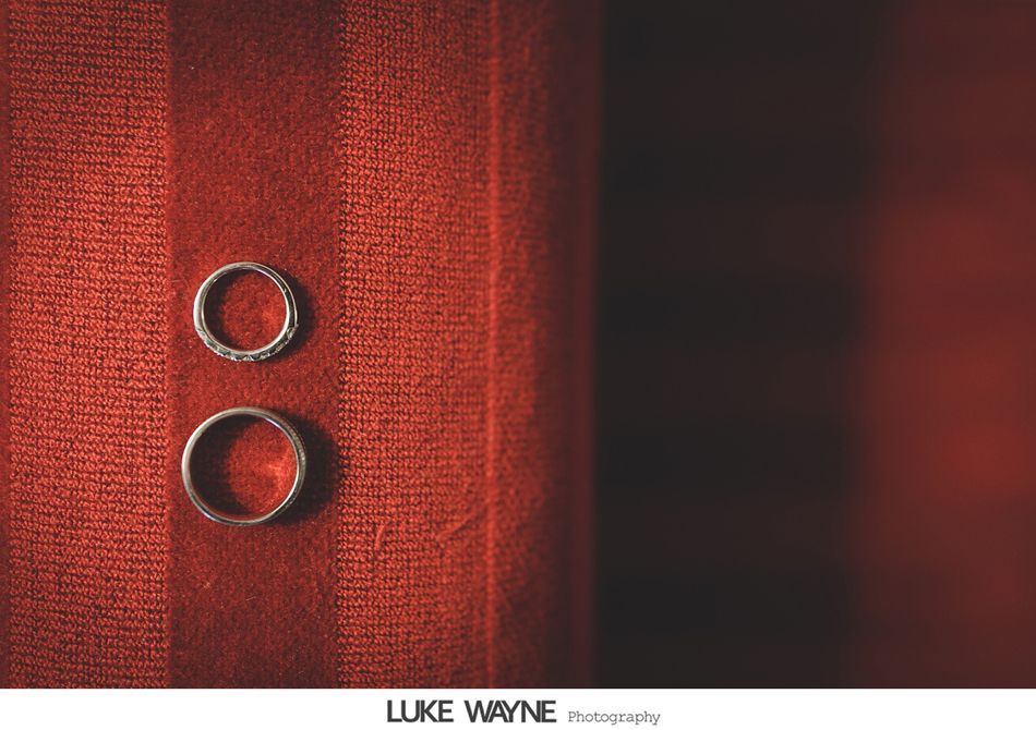Two wedding rings on red fabric.