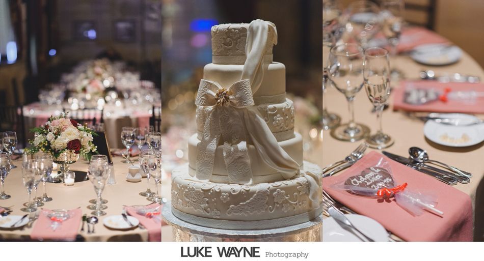 Wedding reception: table settings, tiered cake with bow, and place settings with favors.