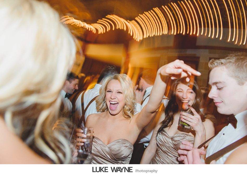 Wedding reception: Dancing guests with joyful expressions. Sparkling lights and champagne.