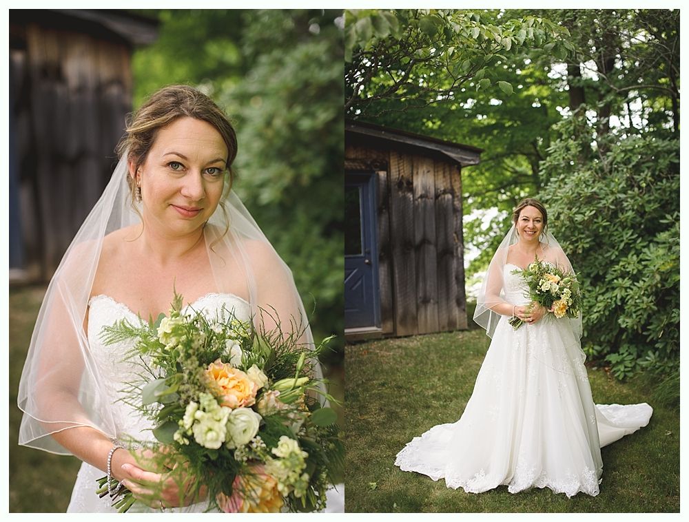 Bride holding a bouquet, wearing a white strapless gown and veil, poses outside a rustic wooden building.