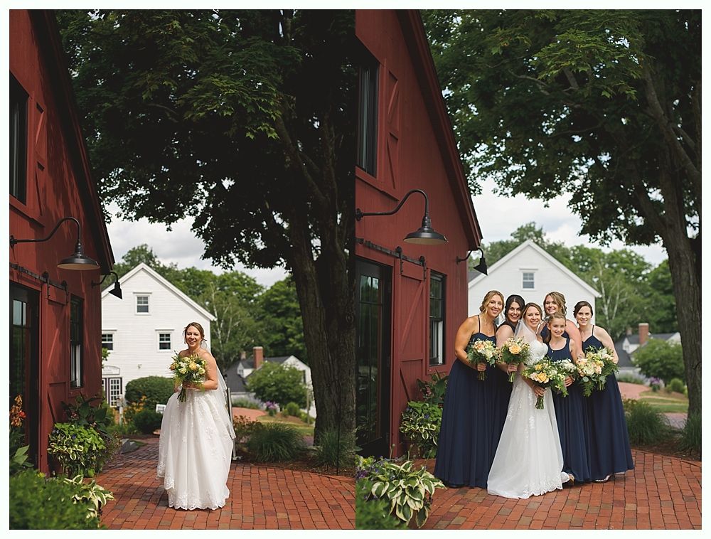 Bride in white dress holding bouquet, posing near red building; bridesmaids in navy dresses.