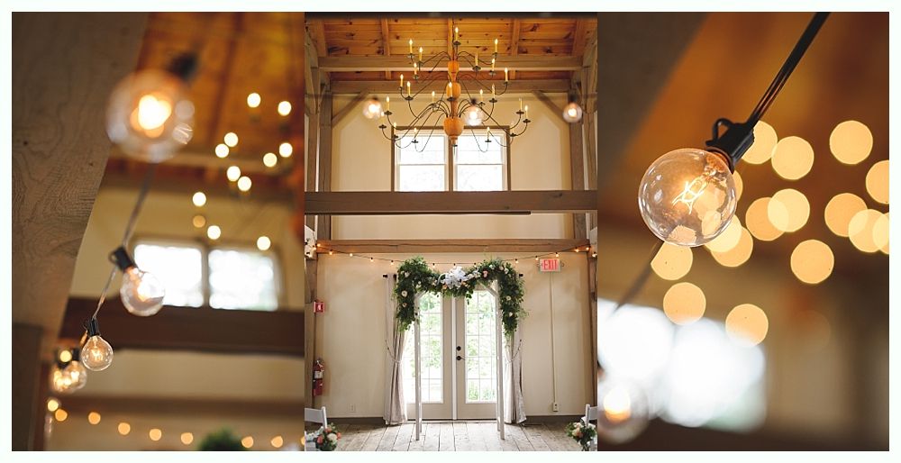 Rustic wedding venue with string lights, chandelier, and floral arch over doors.