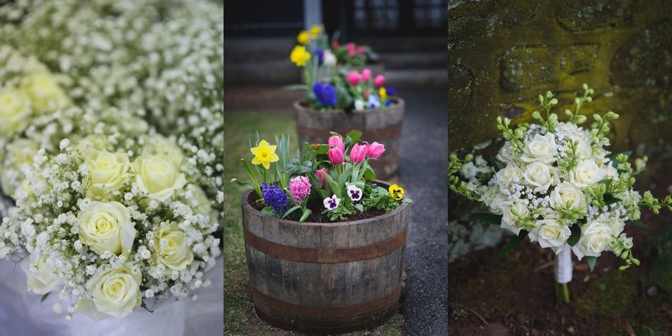 Arrangement of white roses and baby's breath, flowers in wood barrels, and a white rose bouquet.
