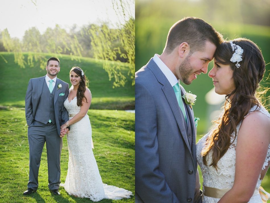 Wedding couple poses outside; man in gray suit, woman in white dress.