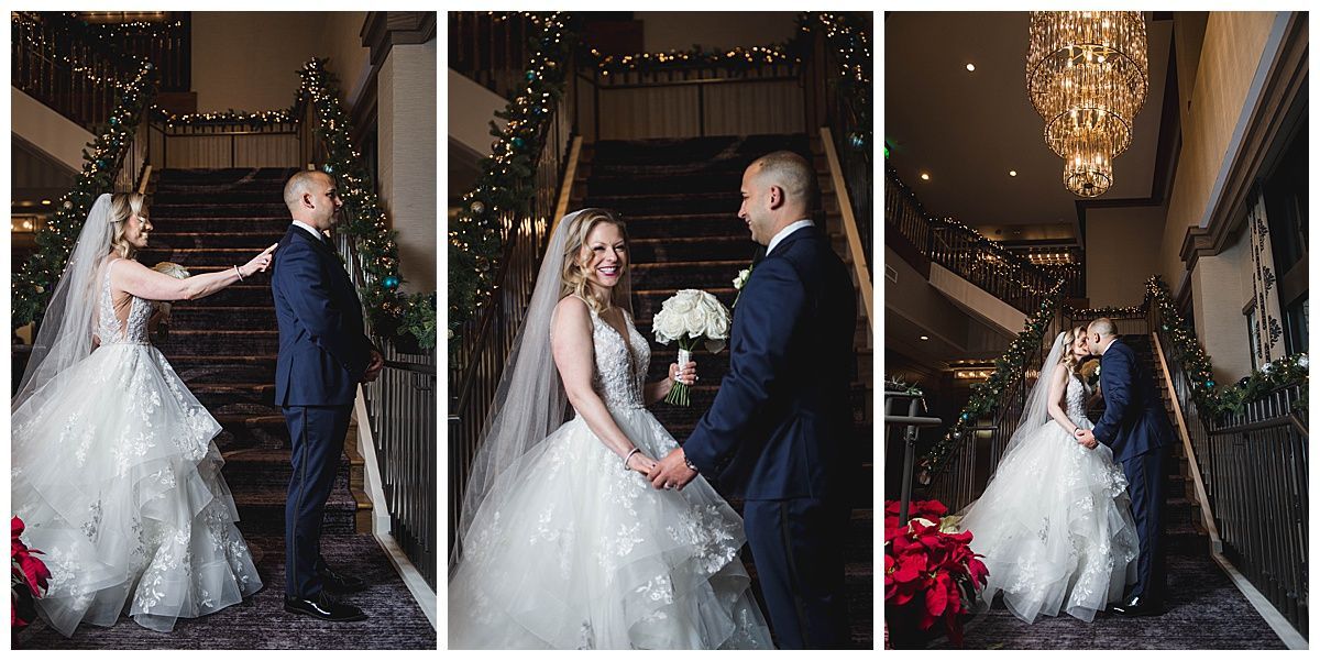 Wedding couple on staircase, she in white gown, he in navy suit, exchanging glances and kisses.