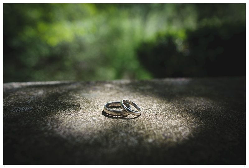 Groom and groomsmen on a beach, wearing suits. Groom in navy pants, others in khaki. All with blue ties, ocean in background.