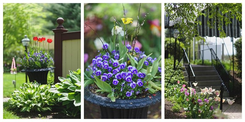 Bride and groom on rocky shoreline, ocean and blue sky background. Groom in suit, bride in white dress, looking at each other.