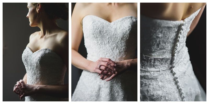 Bride with arms up, making a funny face, groom looking at his hand, cake cutting in background.
