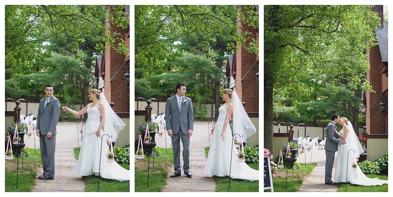 Bride with arms up, making a funny face, groom looking at his hand, cake cutting in background.