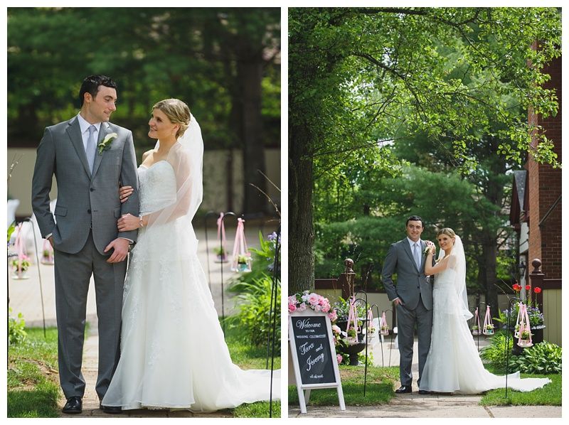 Bride with arms up, making a funny face, groom looking at his hand, cake cutting in background.