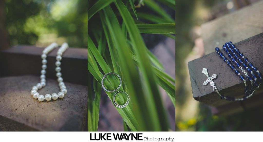 Triptych of wedding details: pearl necklace, rings on leaves, rosary with crucifix on wood.