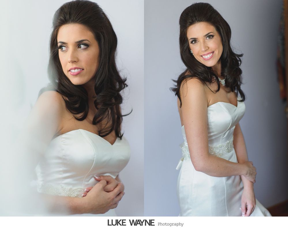 Bride in a white strapless gown, smiling, with dark hair styled up and curled.