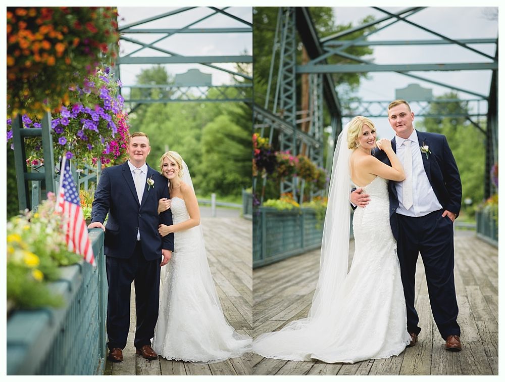 Bride with arms up, making a funny face, groom looking at his hand, cake cutting in background.