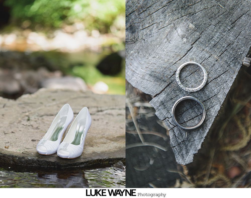 Wedding day preparation: bride in veil, another in a dress looking at her, and a bridesmaid in pink holding a card and purse.