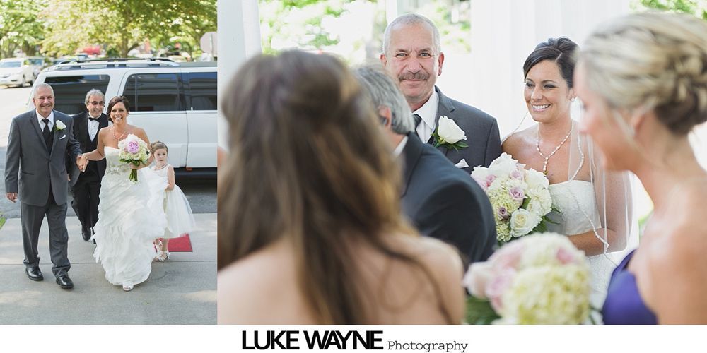Wedding sign on an easel, surrounded by flower arrangements on chairs.