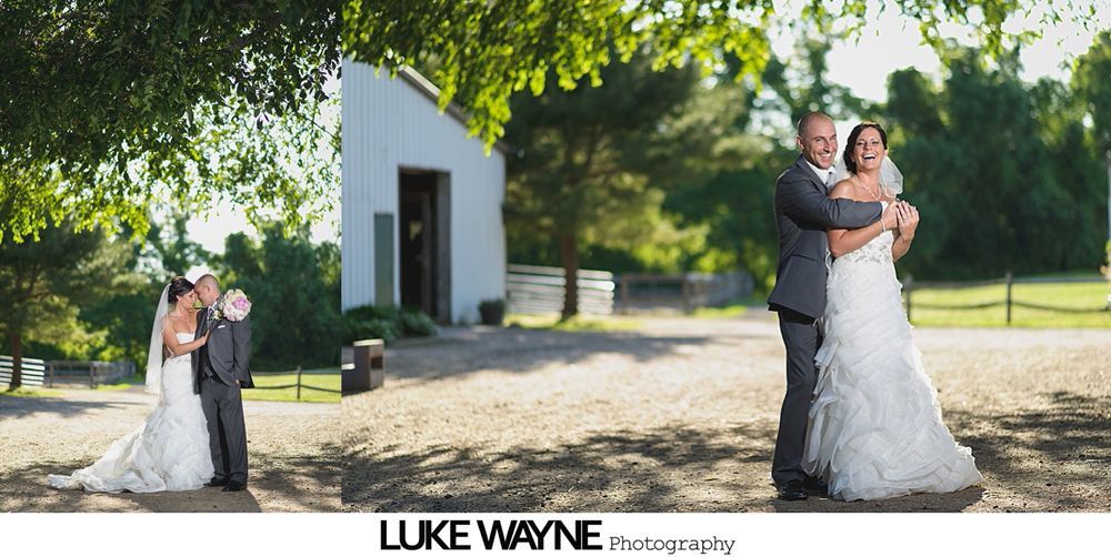 Bride and groom dance closely, illuminated by a back light, during a wedding reception.