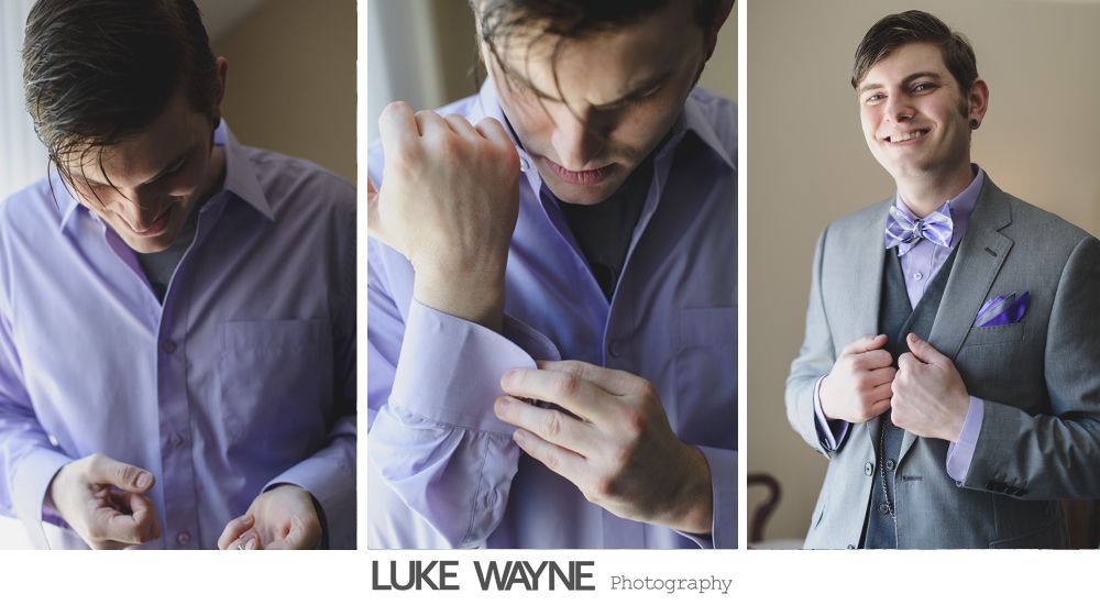 Man adjusting shirt cuffs, then smiling, wearing a gray suit with lavender bow tie and pocket square.