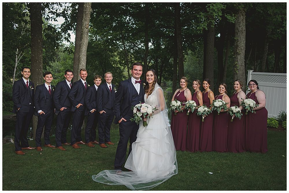 Wedding hands stacked, ceremony, exchange of rings, couple kissing under floral arch.