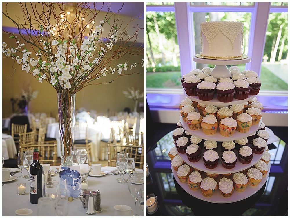 Wedding reception table with floral centerpiece and tiered cupcake display.