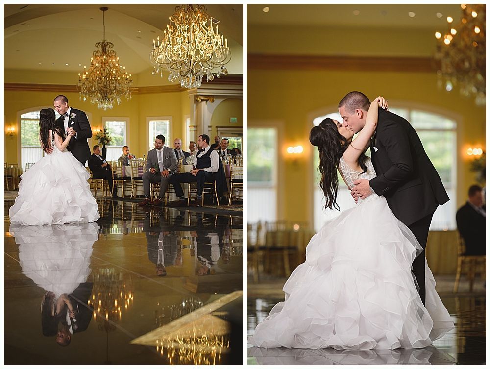 Wedding reception with couple dancing on a glossy floor, ornate chandeliers, and guests seated.