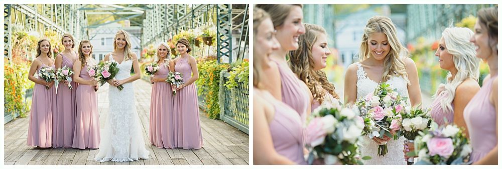 Bride and bridesmaids on a bridge, dressed in white and pink, holding bouquets, smiling.