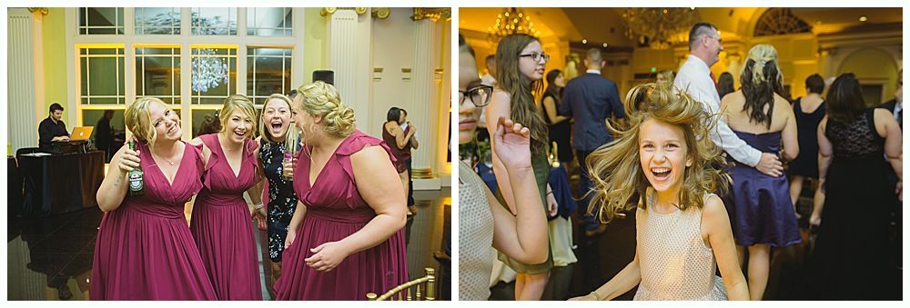 People dancing joyfully at a party, inside a brightly lit room.