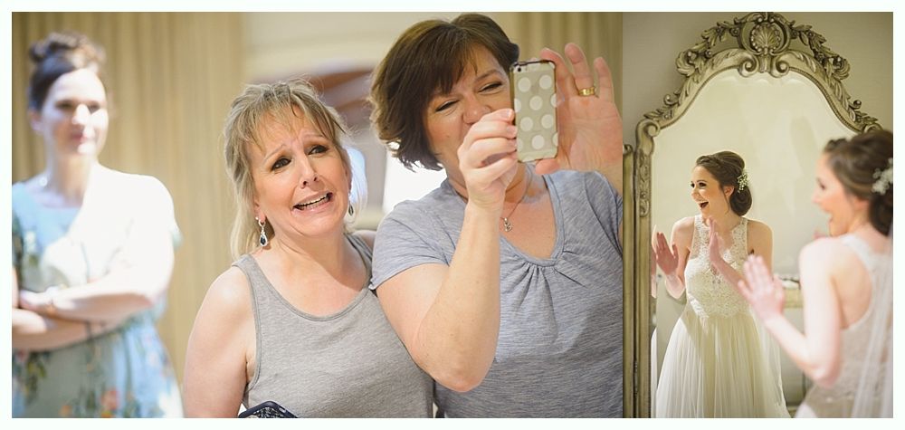 Women react to bride in wedding dress.