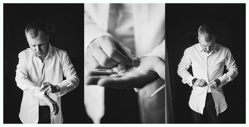 Man in white shirt, buttoning his sleeves and shirt.