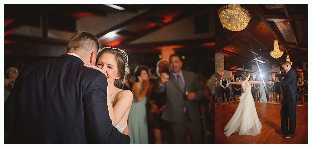 Newlyweds dance at a wedding reception. The bride smiles while dancing with the groom, as guests watch.