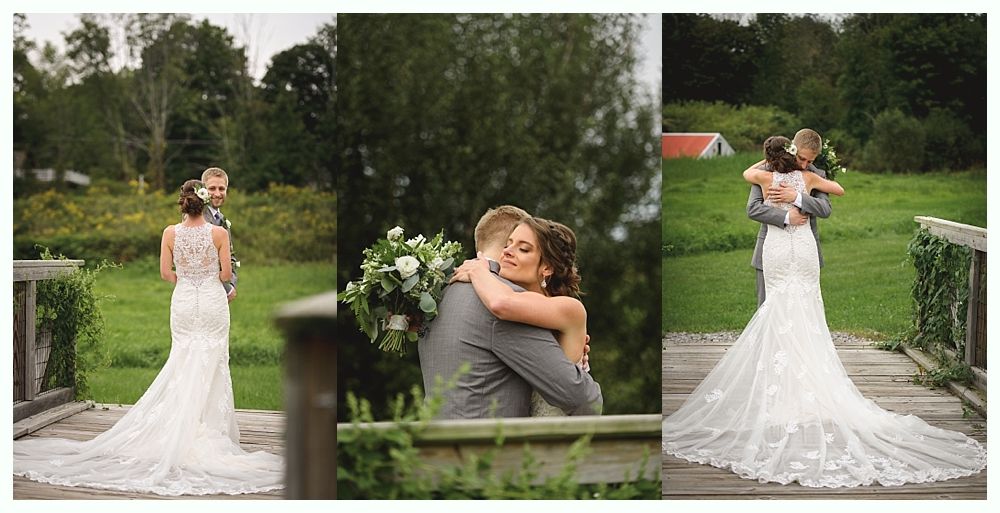 Bride and groom embrace on a bridge; bride wears a lace wedding dress.
