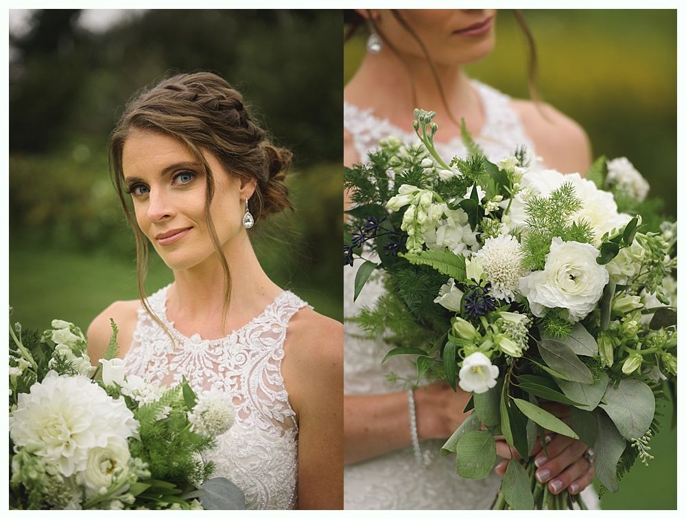 Bride holding a bouquet of white flowers, wearing a lace dress, with hair up, outdoors.