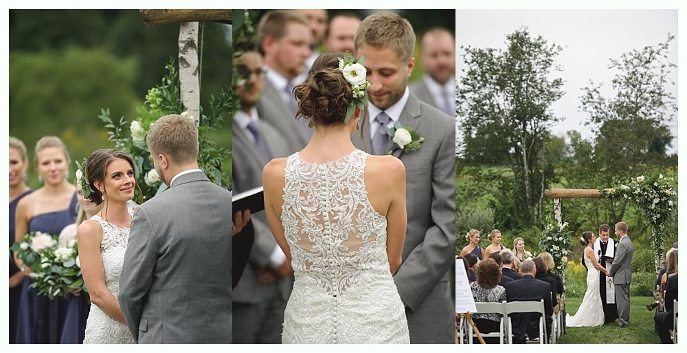 Bride and groom embrace in front of a grand mansion. Sunny day, green lawn.