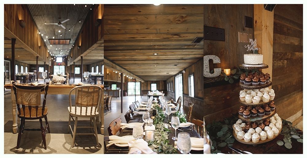 Rustic wedding reception hall with wooden beams, tables set for dinner, and cake.