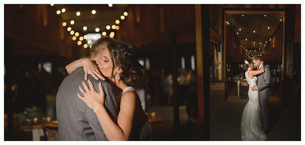 Wedding couple dancing, hugging in a dimly lit venue with string lights.