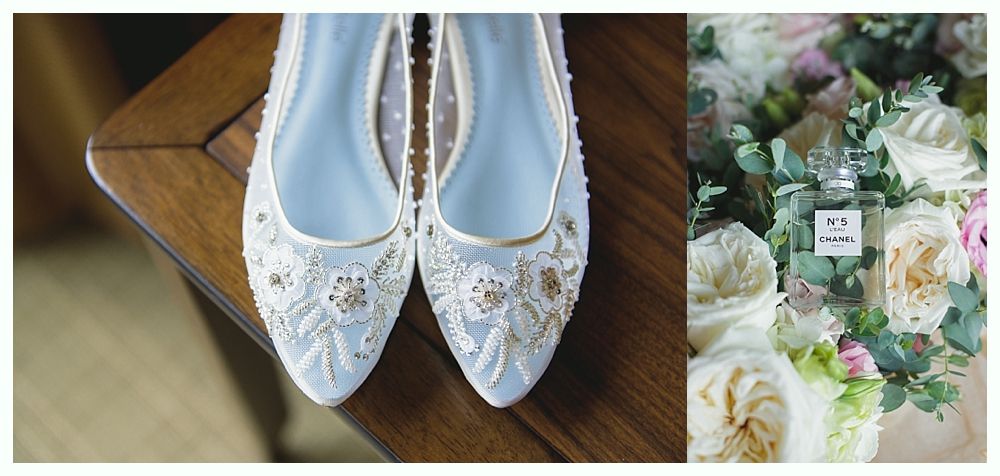 Close-up of embellished, light blue flats and a bouquet with a perfume bottle.