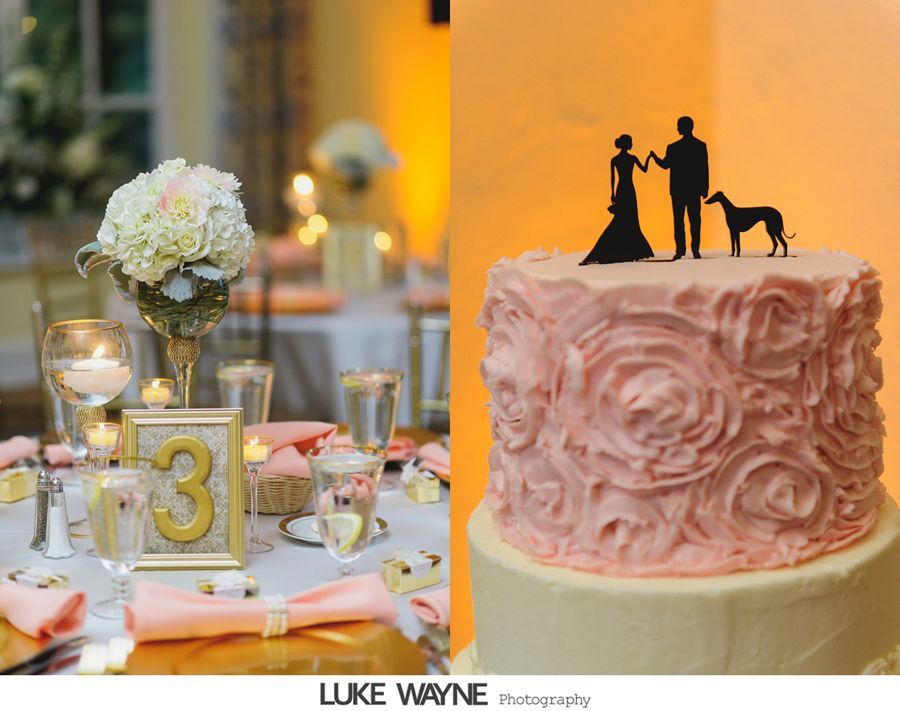 Wedding reception table with floral centerpiece and cake topped with couple and dog silhouette.