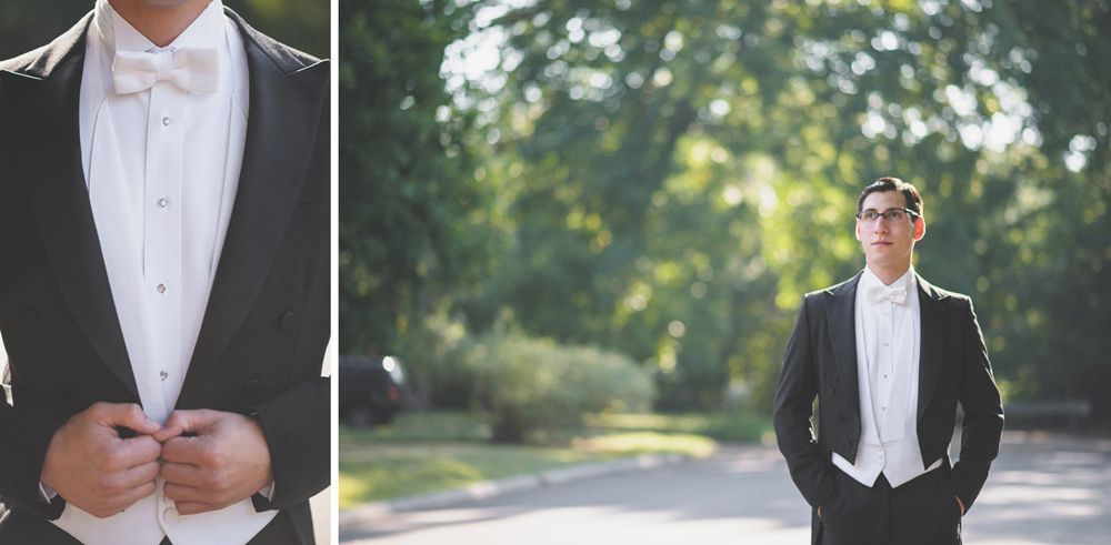 Black and white landscape with a dark, cloudy sky over a field. Sunbeams filter through the clouds.