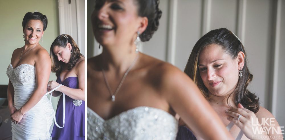 Couple holding hands, smiling; woman in denim jacket, red dress; man in light green shirt, outdoors.