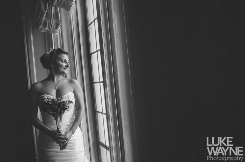 Couple touching noses, silhouetted against a bright background; romantic moment.