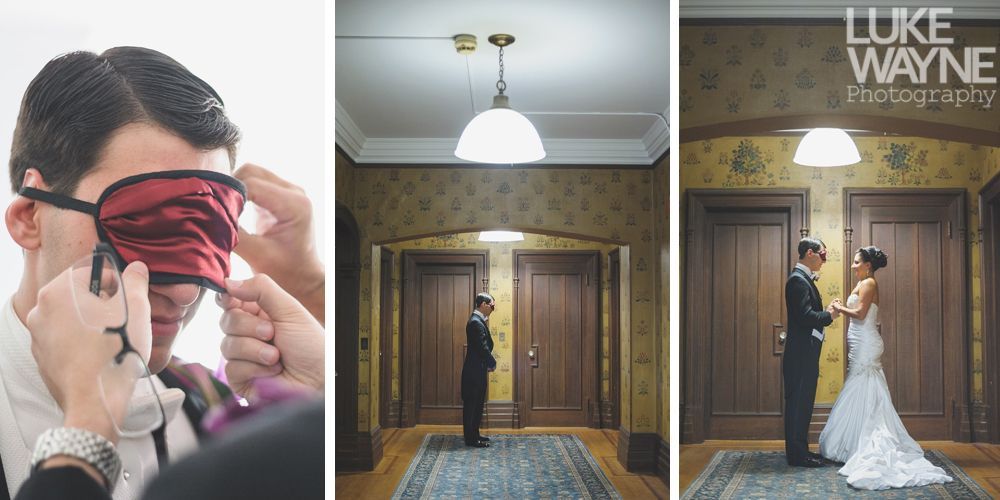 Couple embracing, woman smiling, man's arms around her. Black and white photo, outdoor setting.