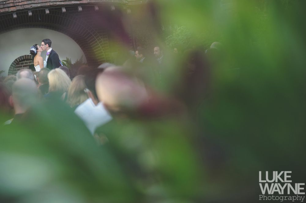 Wedding reception details: cake, flowers, wine, purple and white decor.