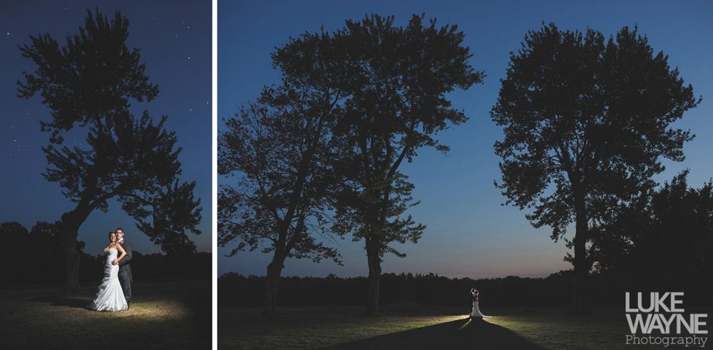 Couple embracing at sunset; man in green shirt, woman in denim jacket and red dress, with blowing hair.