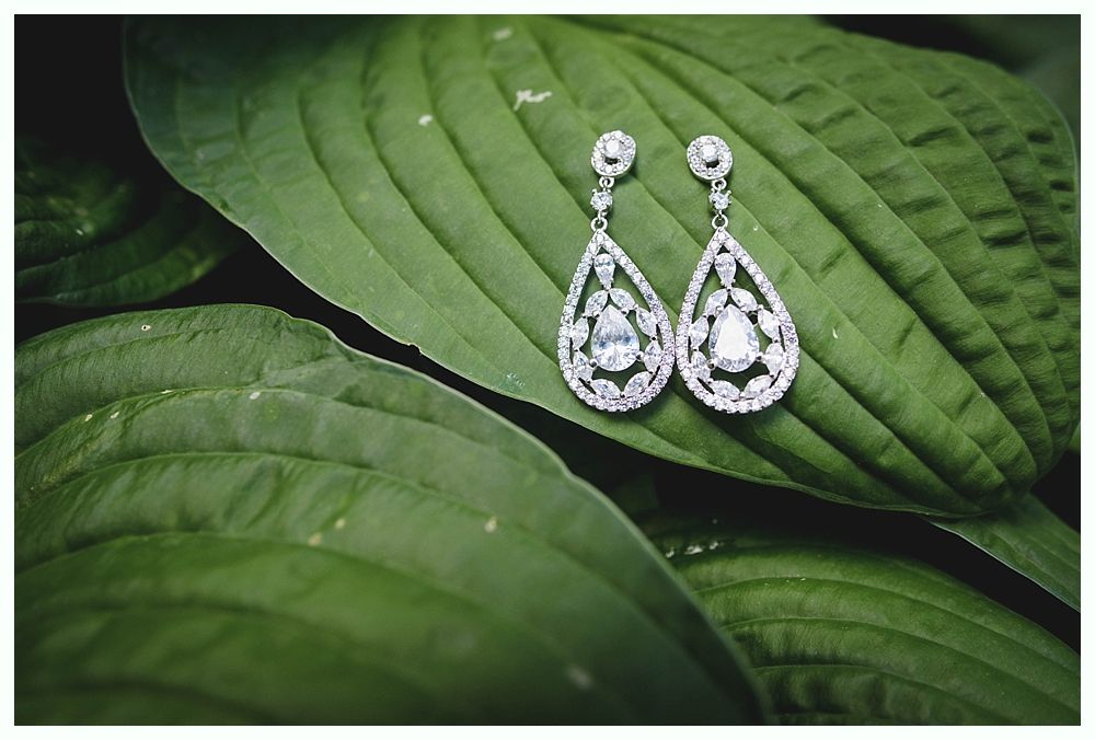 Groom and groomsmen on a beach, wearing suits. Groom in navy pants, others in khaki. All with blue ties, ocean in background.