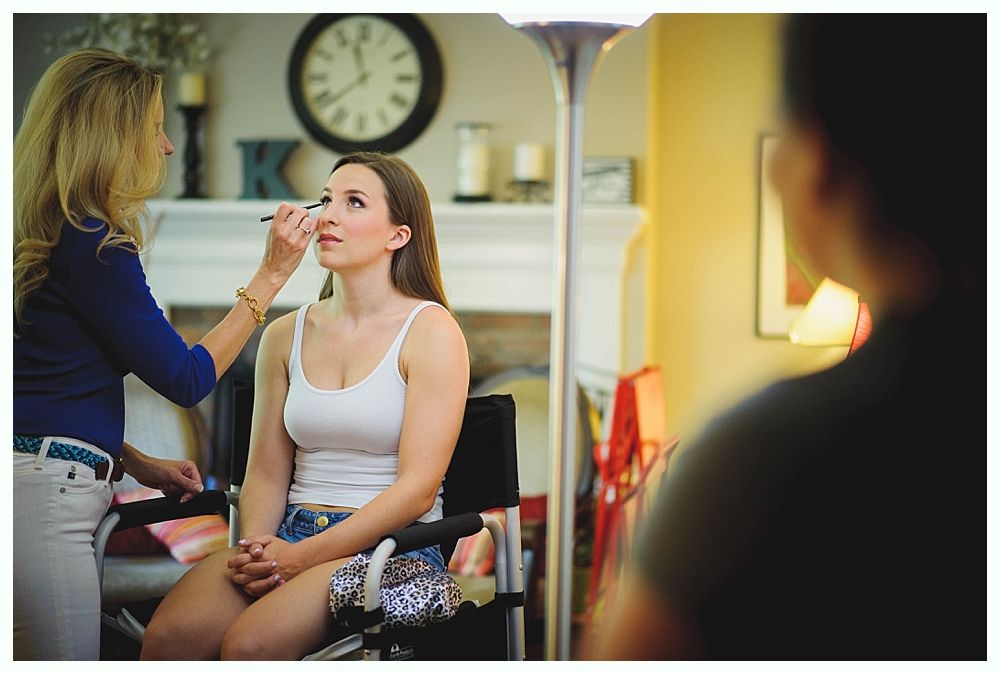 Bride and bridesmaids in navy dresses hold bouquets, posing outdoors.