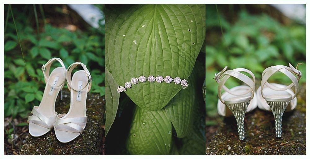 Bride and groom on rocky shoreline, ocean and blue sky background. Groom in suit, bride in white dress, looking at each other.