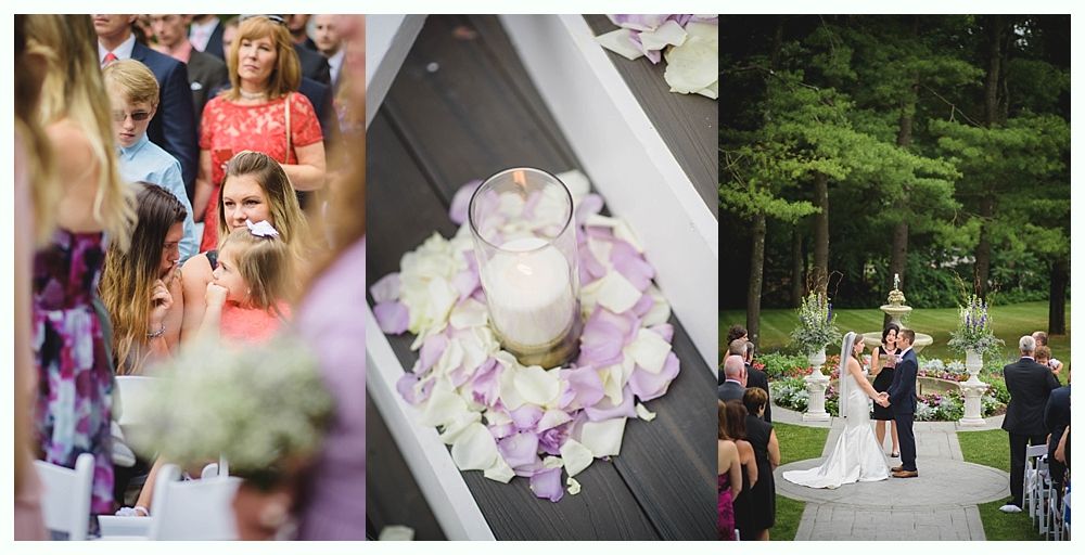 Bride with arms up, making a funny face, groom looking at his hand, cake cutting in background.