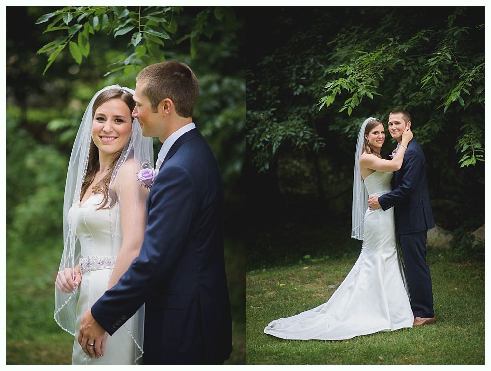 Bride with arms up, making a funny face, groom looking at his hand, cake cutting in background.