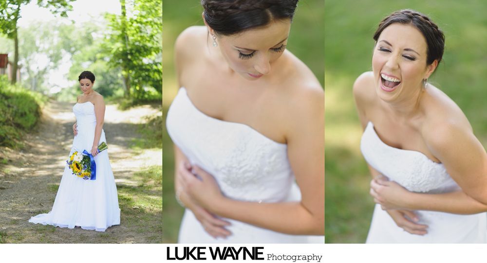 Bride in white strapless dress poses outdoors; laughing, looking down, and holding bouquet on path.